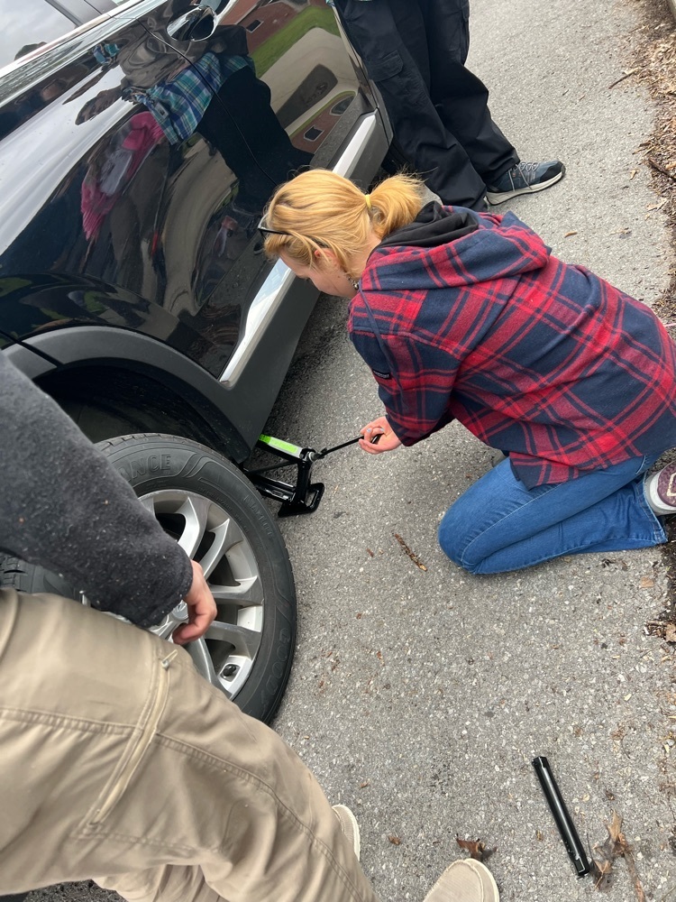 girl changing tire