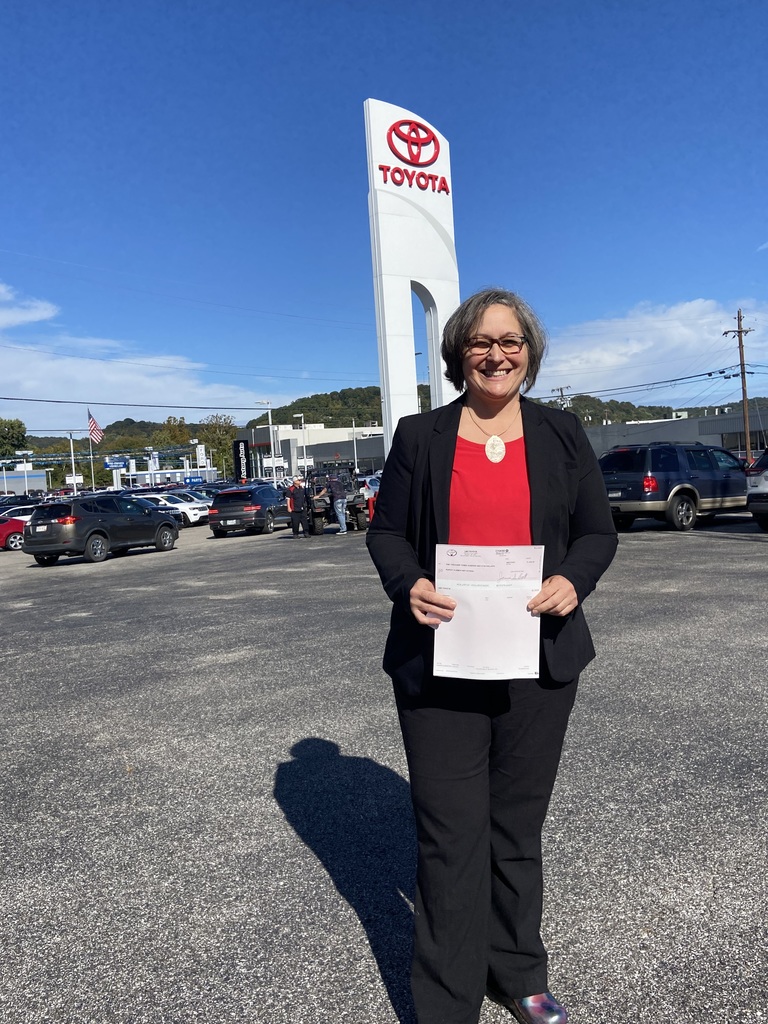 Principal Jenny Harden in front of Toyota