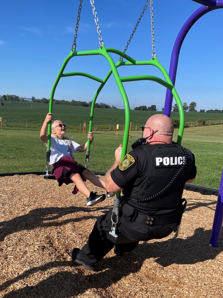 Officer Stalnaker Swinging with student at Ronc. Elem.