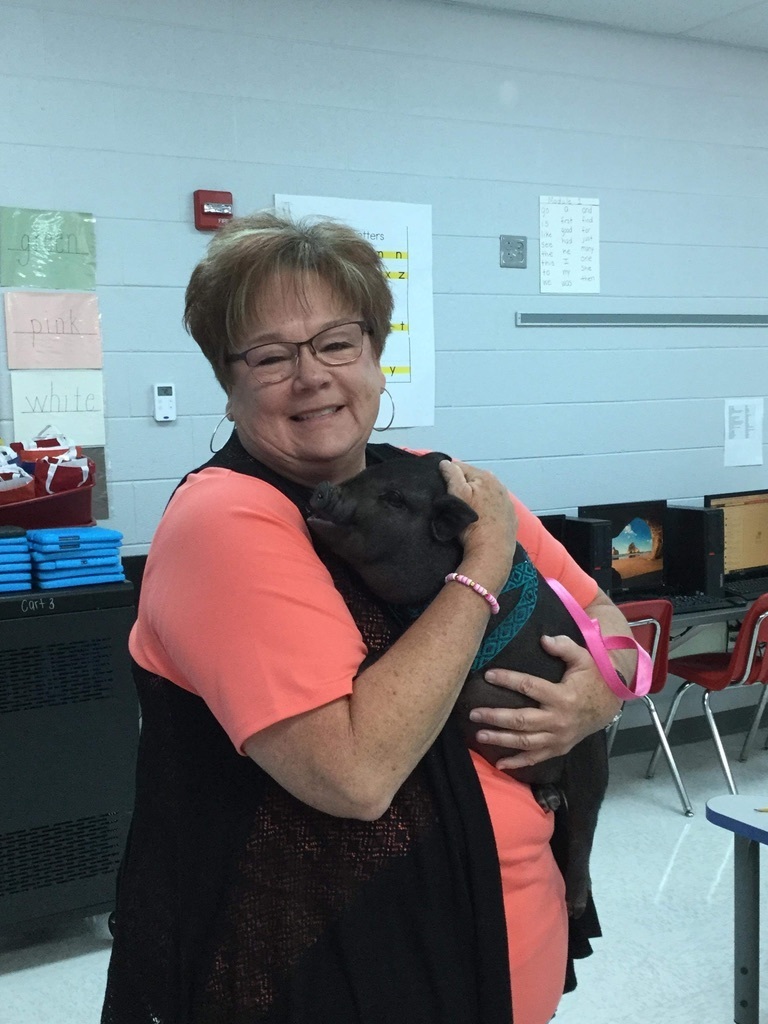 Mrs. Brenda holding the pig