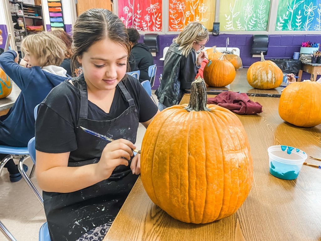 Kids painting pumpkins