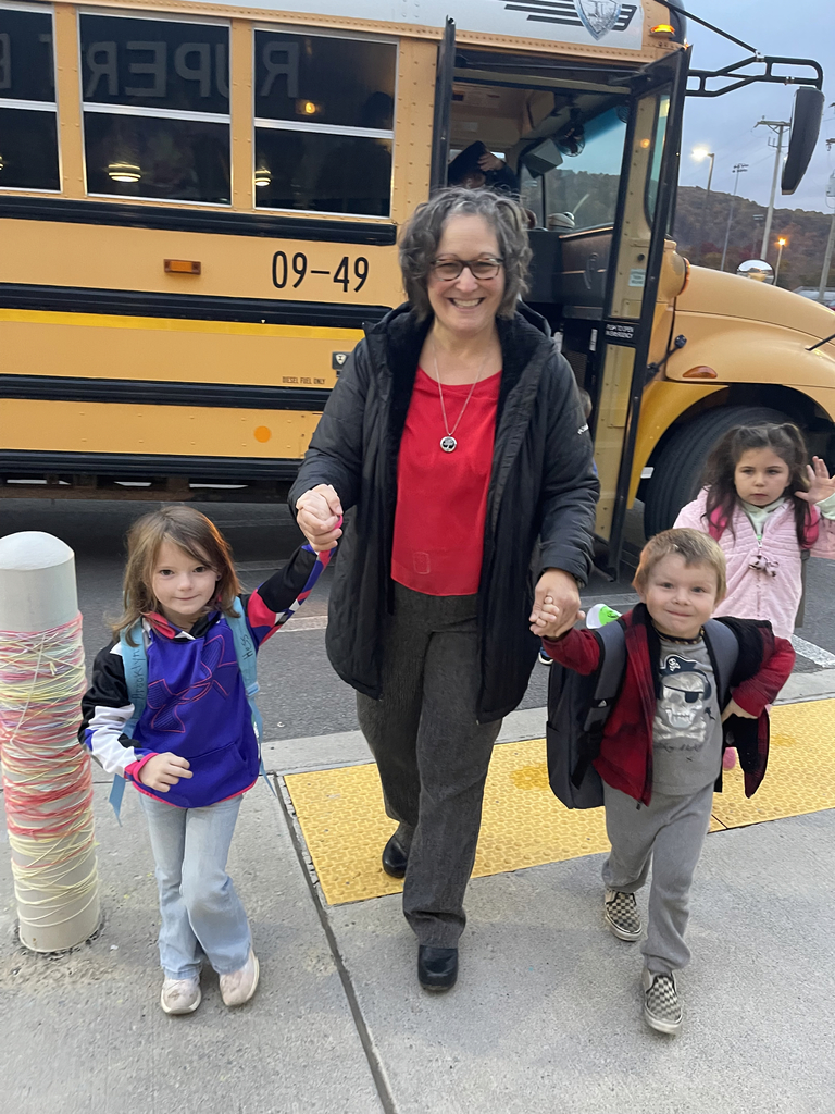 Mrs. Harden assisting students off the school bus